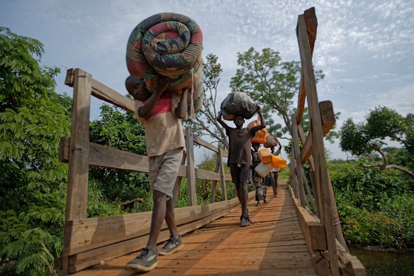 South Sudanese refugees Thomas Wani, 12, brother Peter Lemi, 14, mother Rose Sunday, and father Julius Lezu cross from South Sudan to Uganda during the civil war.