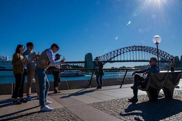 International tourists, such as this group visiting the Sydney Opera House, make a lucrative if underrated contribution to Australia’s economy.