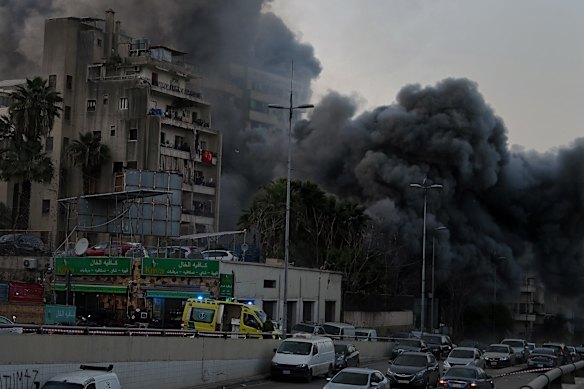 A commercial and residential building in Bachoura District in central Beirut is hit by one of three Israeli air strikes on March 12. 