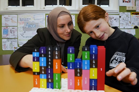 Canterbury Public School teacher Rama Matar with year 3 student Anouk Jago during a lesson on fractions. 