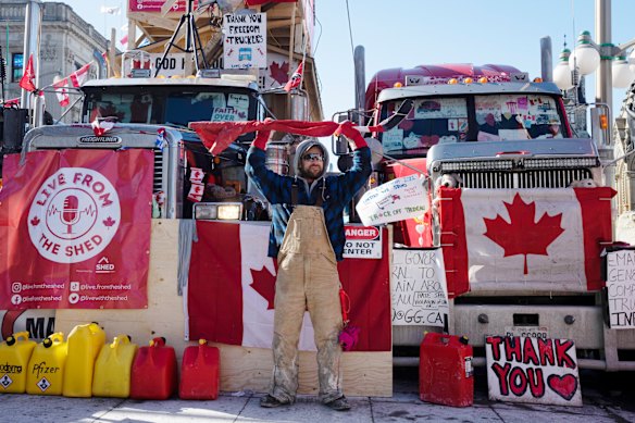 People gather in protest against COVID-19 mandates and in support of a protest against COVID-19 restrictions taking place in Edmonton, Alberta earlier this month. 