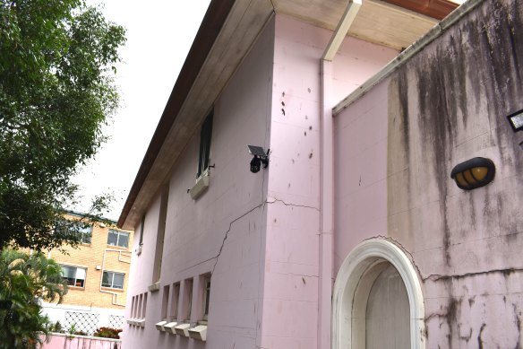 Cracks in the exterior walls, and one of the 12 security cameras.