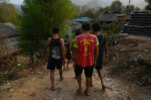 A group of men from Pu Lu Palaw village in Myanmar walk down to the bank of the Moei River on the Thai side of the border.