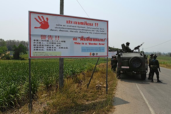 Thai soldiers who are part of the Ratchamanu Task Force combating human trafficking operate a checkpoint close to an unknown Myanmar settlement.