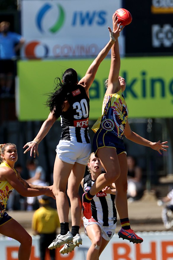 Alison Downie, left, and Caitlin Gould, right, compete for the ball. 