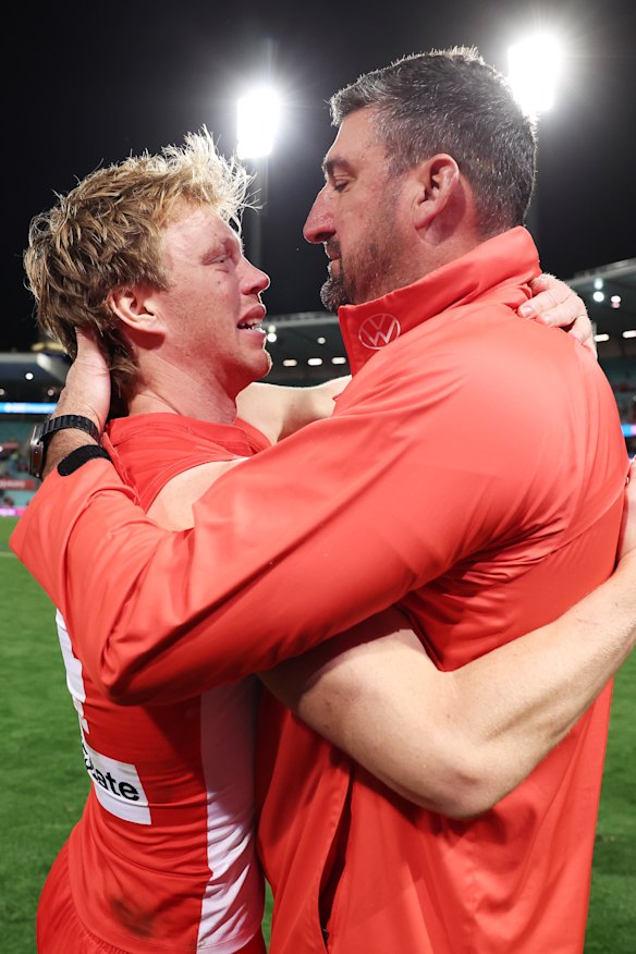 Sydney captain Callum Mills and coach Dean Cox embrace after Sunday’s win over North Melbourne.