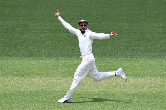 Kohli reacts to the dismissal of Usman Khawaja on day two of the first Test in Adelaide.