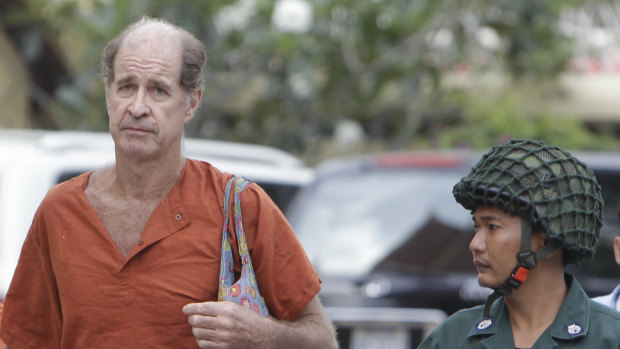 Australian filmmaker James Ricketson is escorted to the Cambodian Supreme Court in Phnom Penh. for a hearing last month.