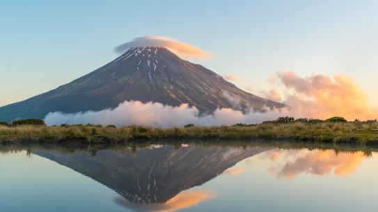 Reflection of Mount Taranaki at sunset. Egmont National Park, North Island, New Zealand. 
