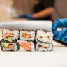 Sushi Hub staff preparing sushi rolls for the lunch rush.