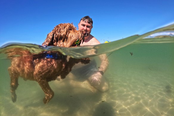 Ben Dunster and Wolfgang take to the water at Middle Park Beach. 