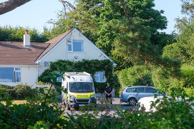Police outside the house of former lawmaker Ann Widdecombe, in Haytor, England