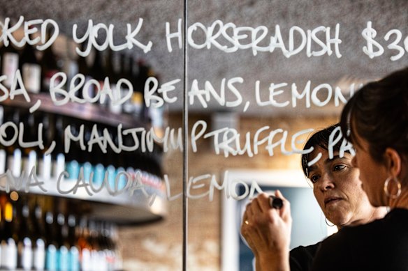 The specials menu is handwritten on a mirror. 