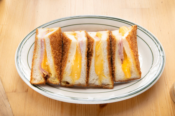 It has two kinds of cheese – American and Swiss – and virginia ham. To serve, it’s quartered into triangles, lined up on an oval plate and dusted with icing sugar.