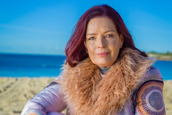 After starting a relationship with Stan Grant, Holmes says she had a “rude awakening” to the issues of race in Australia.