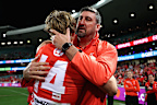 Callum Mills and Dean Cox embrace.