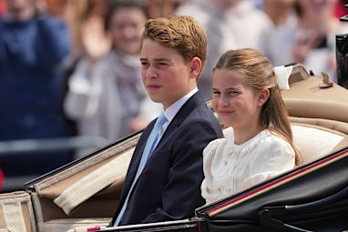 Prince George and Princess Charlotte ride on an open top carriage during Trooping The Colour, the King's annual birthday parade