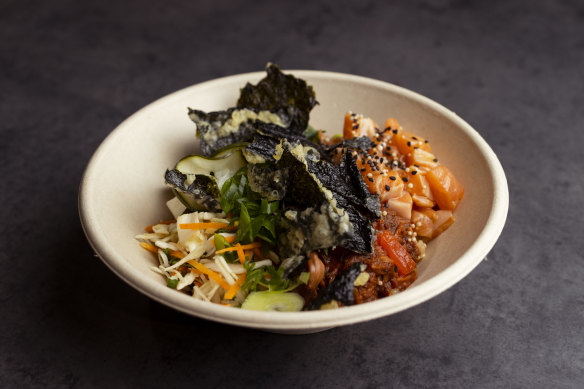 Taco bowl with brown rice, sashimi salmon, jackfruit and pickled cucumber.