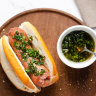 A choripan with chimichurri sauce.