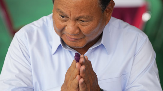 Prabowo Subianto gestures after casting his vote yesterday.
