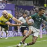 South Africa’s Tristan Leyds, right, is grabbed by his shirt by Australia’s James Turner during the men’s bronze medal Rugby Sevens match.