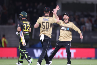 New Zealand’s Jimmy Neesham and Devon Conway celebrate after Neesham’s catch to dismiss Glenn Maxwell.