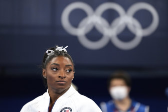 Simone Biles watches on after her shock exit from the team final.