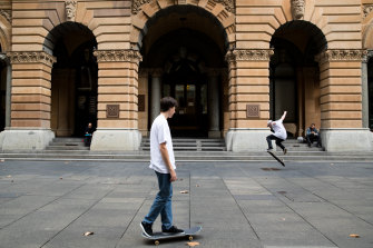 Skateboarders take advantage of a quiet Martin Place in Sydney's CBD during lunchtime. 