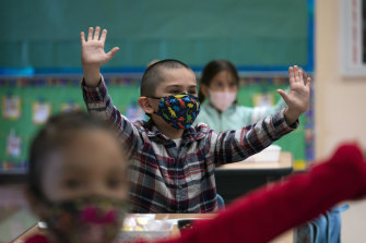 Los Angeles school students wear masks in April. Similar scenes await Victorian classrooms later this month.