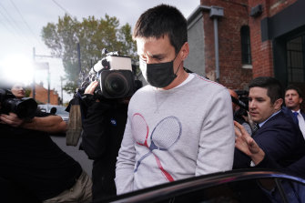 Richard Pusey is led from his home by police in Melbourne on Thursday afternoon.
