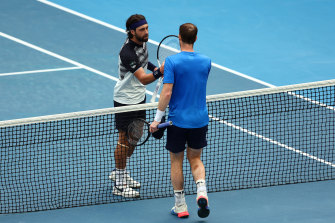 Andy Murray and Nikoloz Basilashvili shake hands. 