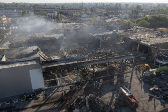 Ukrainian State Emergency Service firefighters search for survivors among debris at the Kremenchuk shopping centre hit by a Russian missile attack.
