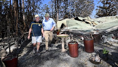 Property owner Stuart Skeen walks with Prime Minister Scott Morrison through his burnt-out property at Binna Burra in the Gold Coast Hinterland.