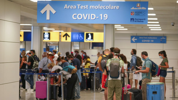 Travellers arrive at Rome's Leonardo da Vinci airport to be tested for the coronavirus as per a new rule imposed last week.