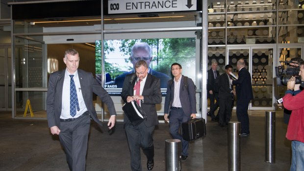 AFP officers leave the ABC Sydney building on June 5.