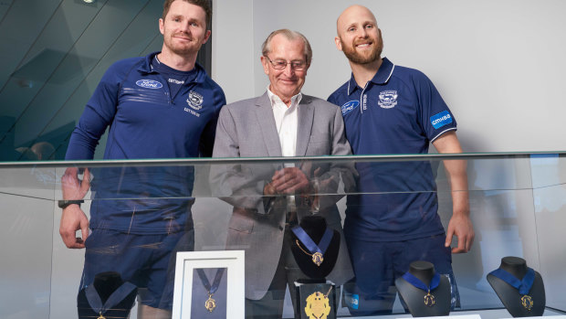 Geelong players Patrick Dangerfield (left), Charles Brownlow and Gary Ablett pose for a photo with the first Brownlow medal at GMHBA Stadium in Geelong. The first Brownlow medal, won in 1924 by Cat's player Edward Greeves, has been purchased by the club and will be on display at the stadium. 