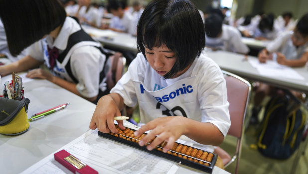 Niko Shibayama, 11, using an abacus, or "soroban" in Japanese, during an event in Kyoto.