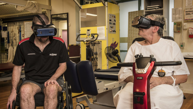 Joshua Gough, left, uses a VR headset at Prince of Wales Hospital.