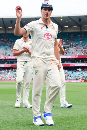 Pat Cummins leaves the field after taking five wickets.