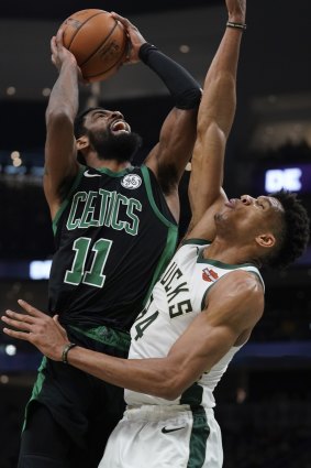 Kyrie Irving shoots over Giannis Antetokounmpo.
