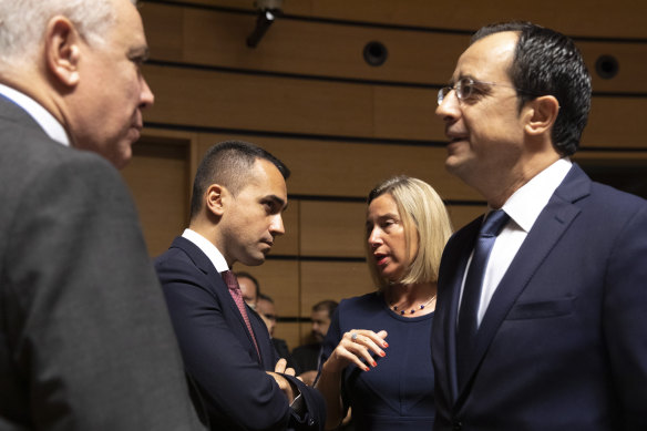 Italian Foreign Minister Luigi Di Maio (centre left) speaks with European Union foreign policy chief Federica Mogherini (centre right) in Luxembourg on Monday as some EU nations seek to extend trade restrictions against Turkey. 