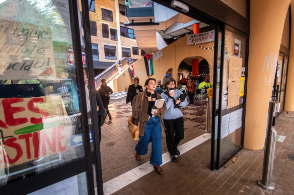 Students walk through the doors at the Arts West building at the University of Melbourne on Friday.