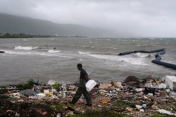 A man walks along the coastline during Hurricane Melissa in Kingston, Jamaica. 