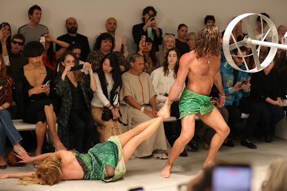 A model dragging Kirsha Kaechele on the runway of the Iordanes Spyridon Gogos show at Australian Fashion Week.
