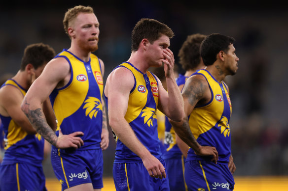 West Coast players walk from the field after losing to Fremantle.