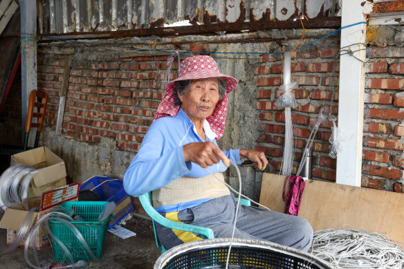 Chen Wan-Hao works on fishing tools at a village near Xiyu Island, Penghu, an archipelago of 90 islands and islets in the Taiwan Strait.