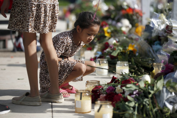 A child looks at a memorial site for the victims killed in this week’s shooting at Robb Elementary School.