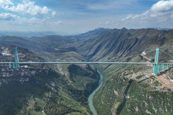 The Huajiang Grand Canyon Bridge stretches above a yawning gorge in south-west China.
