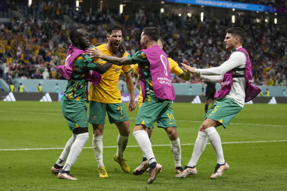 Mathew Leckie and his Socceroos teammates celebrate his goal against Denmark.