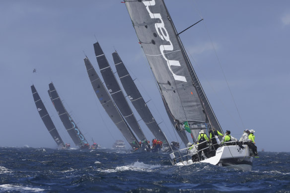 The fleet sails out of the heads during the 2021 Sydney to Hobart race start.